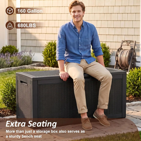 Heavy Duty 160 Gallon Deck Box Crafted From Weatherproof Resin With Secure Locking Lid, man sitting on box in backyard.