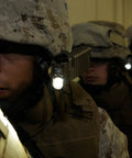 Military personnel using Sidewinder 55-Lumen LED Aviation Waterproof Flashlight with helmet and MOLLE mount in a dim hallway.