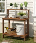 Tioman Outdoor Potting Bench In Natural Hardwood For Small Patios And Balconies With A Tall Open Frame And Slatted Shelves That Drain Water Big On Workspace And Handy Storage For Tools And Plants in a garden setting