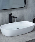 28x15 Inch Oval Porcelain Vessel Sink White Ceramic Above Counter Bathroom Basin for Vanity Cabinet with water running faucet