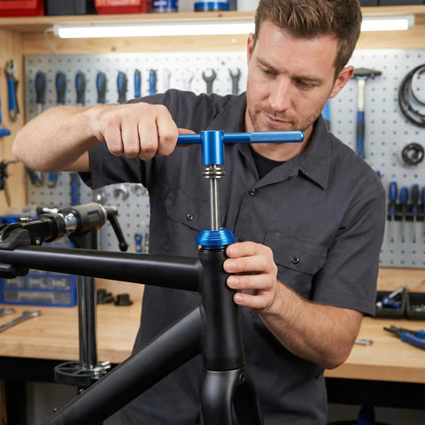 Man using Pro Grade Bicycle Bottom Bracket Installation Tool Set for Press In BB Axle and Headset in workshop