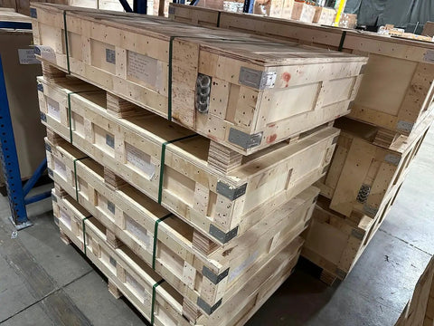Heavy Duty Electric Hydraulic Scissor Lift Table With Beefy Steel Build And Massive 13200 Lb Capacity For The Garage Or Warehouse Easy Foot Pedal Lift stacked with wooden pallets.