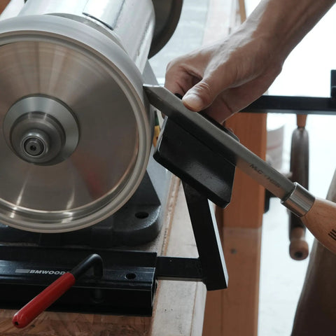 Total No Sweat Setup For Your Shop This Upgraded Grinding Jig System Cranks Out Razor Sharp Edges On Wood Chisels Turning Tools And Bowl Gouges Using Standard Eight Inch Grinders shown sharpening a tool.