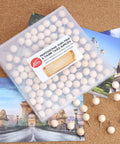 Top Shelf Wooden Push Pins, 120 Pack Of Straightforward Thumb Tacks For Corkboards And Bulletin Boards in a clear container on a corkboard.