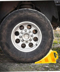 2 Pack Heavy Duty Rubber Wheel Chocks positioned against a truck tire with rock solid grit treads and sturdy handles.