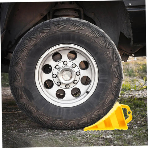 2 Pack Heavy Duty Rubber Wheel Chocks positioned against a truck tire with rock solid grit treads and sturdy handles.