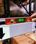 Savage Digital Magnetic Torpedo Level, 9 Inch Aluminum Billet, Orange, Displaying 0 Degrees on Metal Shelf, Warehouse Setting