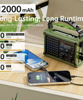 Emergency Solar Radio With Hand Crank And 12000mAh Battery Pack charging phones on a table outdoors