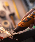 WEN 23190 rotary tool in orange and black, handheld, grinding metal with sparks.