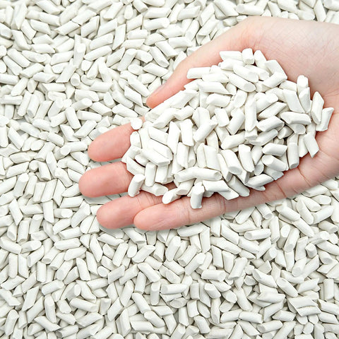 Hand holding Eight Pound Ceramic Tumbling Media Cylinders, Reusable Non Abrasive Pellets 1/5 x 2/5 Inch for Lapidary Tumblers
