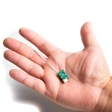 Hand holding Ultra Tiny SRXL2 DSMX Serial Micro Receiver For RC Gearheads, 2.4GHz DSMX Link With Smart G2 Capabilities, Model SPM4650.