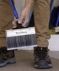Person holding Large 7 Inch Deck Stain Brush With Extra Thick Bristles for thorough staining of wood and fences, includes pole.