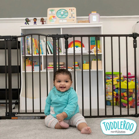 Toddler sitting in front of 3 In 1 Arched Decor Metal Superyard Play Yard 6 Panel Playpen baby gate extra wide fence 30 inches tall