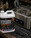 Pro Grade Ultrasonic Gun Cleaner Solution That Hits Different On Stubborn Carbon And Gun Oil With Zero Hard Scrubbing One Concentrated Gallon Mixes Straight Into Two Hundred Ready To Shoot Parts USA Made in use with metal basket in ultrasonic cleaner.