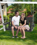 All Weather Outdoor Hanging Porch Swing For Two Seats With Cup Holders Durable Plastic Patio Swing Bench With Chains For Courtyard And Garden Weatherproof And Low Maintenance For Backyards in garden setting