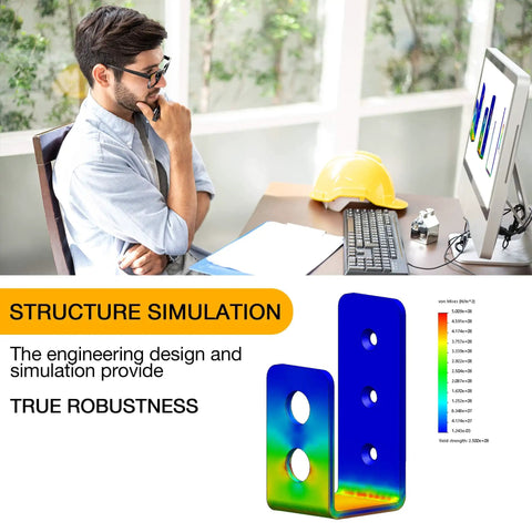 Engineer analyzing structure simulation on computer screen with color-coded diagrams, hard hat on desk