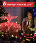 Woman with gift beside Solar Star Jellyfish Garden Lights Six Pack With Color Changing Fiber Optic Glow for festive decor