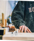 Pro Grade Dowel Centering Pins For Woodworking Center Transfer Plugs in use on a wooden plank for precise hole alignment.