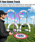 Person controlling drone in DIY Obstacle Course Kit For Drones Dope Hoop Gates And PVC Track For 23.6 Inch Quadcopter FPV RC Racing Training Set Stable Crashproof Obstacle Course For Practice Competitive Drills And Custom Track Building with colorful gates and flags in park.