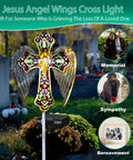 Solar Glass Cross Garden Stake Light with Angel Wings and Stained Glass Look in cemetery setting for memorial decor.