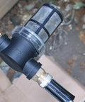 Inline Garden Hose Water Filter For Well Water With 100 Mesh Screen Sediment Filter Attachment close-up in outdoor setting