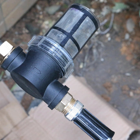 Inline Garden Hose Water Filter For Well Water With 100 Mesh Screen Sediment Filter Attachment close-up in outdoor setting