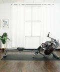 Phantom Hydro Water Rowing Machine With Realistic Water Resistance 60 Degree Tank 16 Hydro Blades in home setting with mat