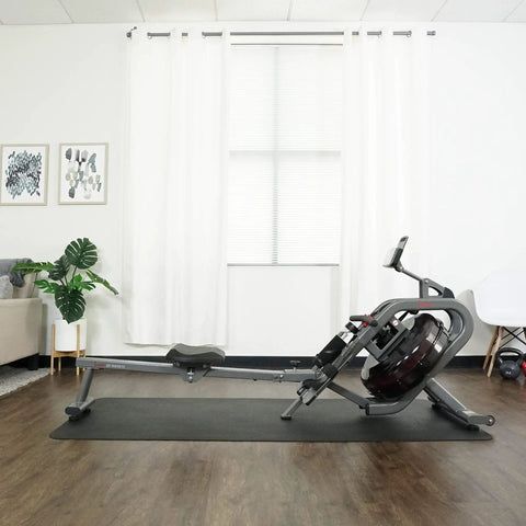 Phantom Hydro Water Rowing Machine With Realistic Water Resistance 60 Degree Tank 16 Hydro Blades in home setting with mat