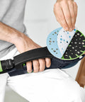 Person applying Granat 100 Grit 6 Inch Sanding Discs For Orbital Sander 100X Pro Grade Long Lasting Abrasives to a power sander
