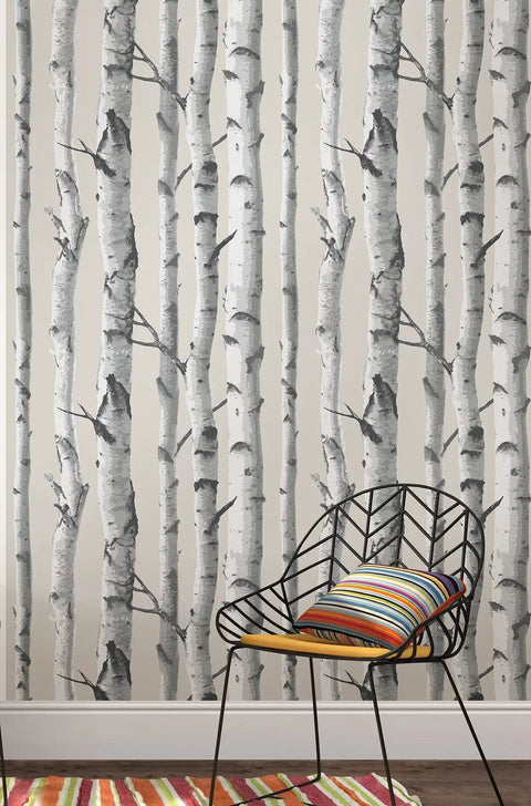 Mountain Birch Peel And Stick Wallpaper Grey For Walls Easy To Install Repositionable No Residue Safe On Painted Surfaces Ideal For Rentals And DIY Decor That Sticks To Smooth Flat Surfaces on a wall with a black chair and colorful cushion.