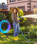 Woman using 3-In-1 Garden Hose Holder With Solar Light And Shepherd Hooks, Freestanding Hose Storage For 160 Inch Hose in garden