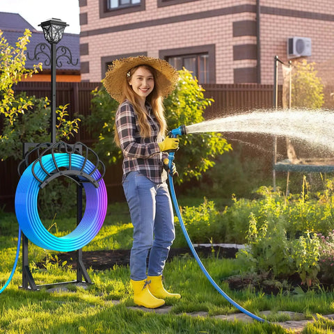 Woman using 3-In-1 Garden Hose Holder With Solar Light And Shepherd Hooks, Freestanding Hose Storage For 160 Inch Hose in garden