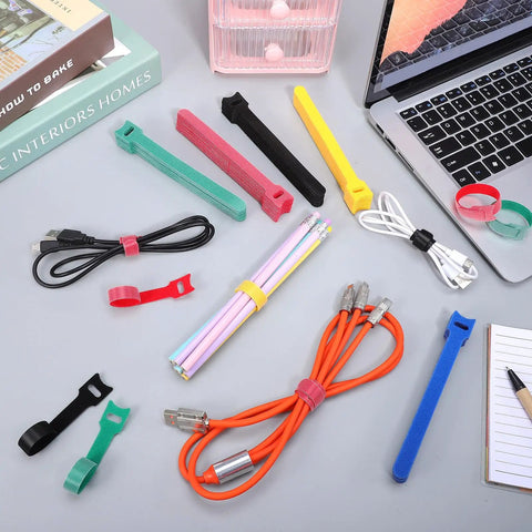Colorful nylon reusable cable ties, assorted sizes, on desk with wires and stationery. Ditch The Cord Chaos And Snag These Ridiculous 100 Piece Reusable Nylon Cable Ties Color Coded Wire Organizers For Zero Stress Tech Setup And Clean Workspace Storage.