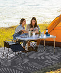 Outdoor Rug For All Weather Use Waterproof Plastic Straw Style Mat Large 5x8 Area Rug For Outdoor Living Yard Vibes Patio Deck Backyard RV Beach Balcony Porch White And Gray shown in use at campsite with tent and table