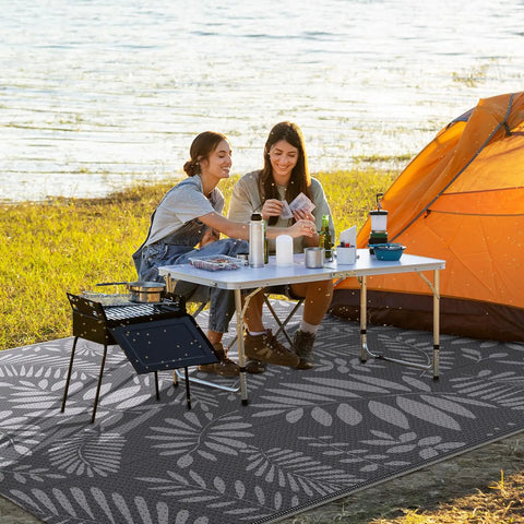 Outdoor Rug For All Weather Use Waterproof Plastic Straw Style Mat Large 5x8 Area Rug For Outdoor Living Yard Vibes Patio Deck Backyard RV Beach Balcony Porch White And Gray shown in use at campsite with tent and table