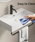 HAOCHRYSYPH Ceramic Wall Mount Sink with Towel Rack, Milk White, 23.63 in. being cleaned with a cloth.