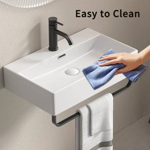 HAOCHRYSYPH Ceramic Wall Mount Sink with Towel Rack, Milk White, 23.63 in. being cleaned with a cloth.