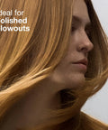 Woman with polished blowout hairstyle using Express Ion Aluminum Round Brush For Blow Drying All Hair Types Large Vented Barrel