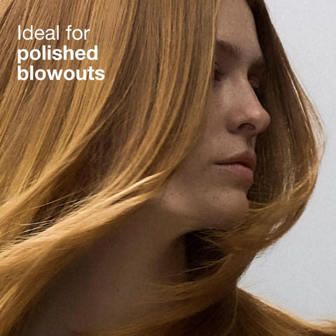 Woman with polished blowout hairstyle using Express Ion Aluminum Round Brush For Blow Drying All Hair Types Large Vented Barrel