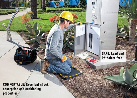 Person using Medium Shock Absorption Kneeling Pad 14 By 21 Inches Black With Handy Handle for outdoor electrical work.