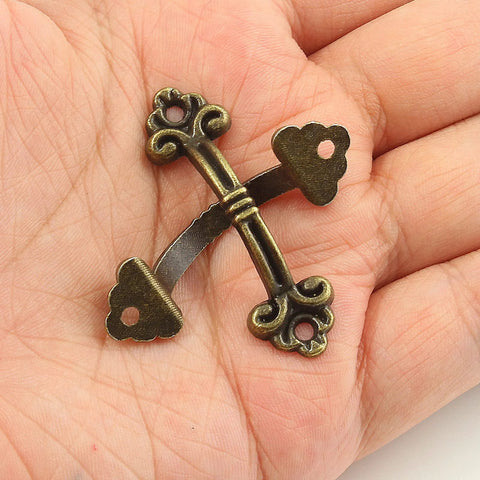 Close-up of a Vintage Mini Drawer Pull in bronze zinc alloy held in hand, part of a 20 Pack Bronze Zinc Alloy Antique Style Handles with Mounting Screws.