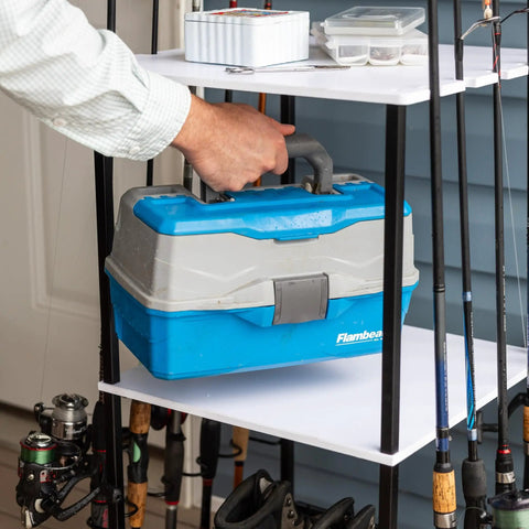 Man placing tackle box on Garage Fishing Pole Organizer That Holds Ten Rods, Reels, Tackle Box, And Gear With Built In Shelves