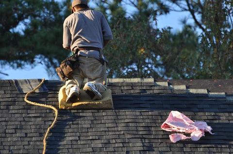Heavy Duty Roofing Cushion With Killer Traction And Heat Blocking Kneeler Mat for a roofer kneeling on a steep roof.