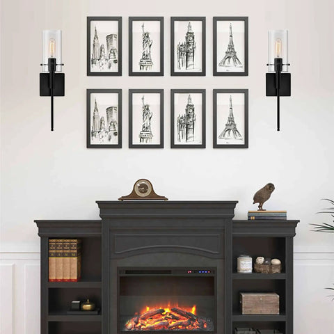 Modern Indoor Wall Sconces Set Of 2 In Bronze With Clear Glass Shades Sleek Minimalist Bedroom And Living Room Lighting Easy Two Way Install Durable Bronze Finish Perfect Accent Lights For Home Decor displayed on either side of framed sketches above a fireplace.