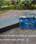 AM FM Radio Kit For DIY Soldering Projects And Electronics Teaching Hands On STEM Gift shown with black gift box outdoors