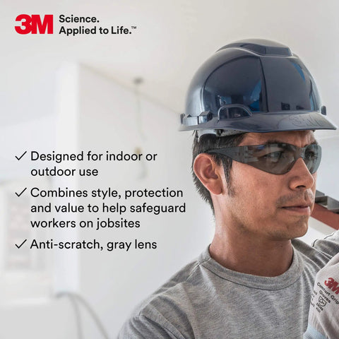 Person wearing lightweight unisex safety glasses with wraparound coverage ANSI Z87 high impact gray hard coat lens.