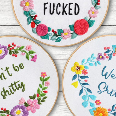 Three Sets Of Funny Embroidery Kits For Beginners With Flower Wreath Pattern And Funny Words Pattern DIY Easy Cross Stitch And Needlepoint Starter Kit For Adults Includes Clear Instructions And Colorful Threads, showcasing colorful hoops with floral wreath designs and humorous phrases.