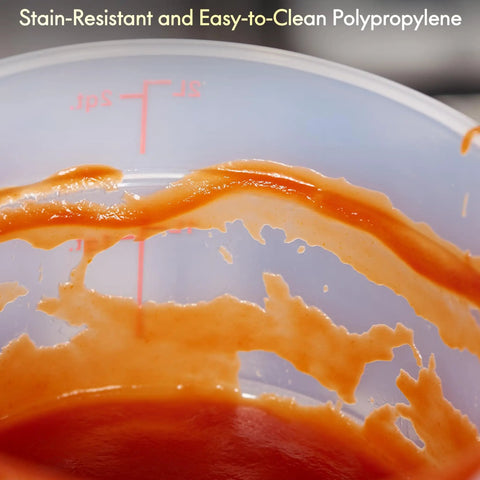 Close-up of 2 Quart Translucent Round Food Storage Containers With Lids Pack Of 4 Nonstick BPA Free NSF Listed Commercial Grade Polypropylene Freezer And Dishwasher Safe Easy Read Graduations Perfect For Quick Meal Prep And Leftovers, showing tomato sauce stains and graduations.