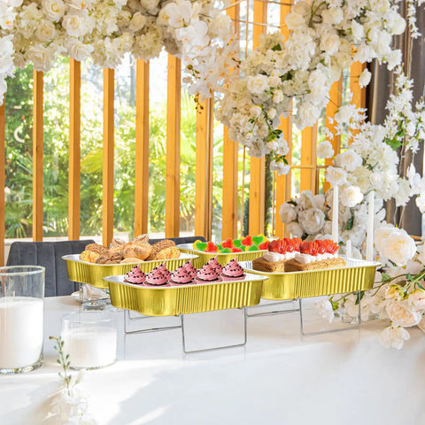 Four Sets Disposable Chafing Dishes Buffet Set with Chafer Wire Racks on decorated table, aluminum pans with lids for parties, large fuel not included.