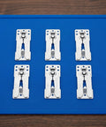 Six Piece Heavy Duty Stainless Steel Sectional Couch Connectors Featuring Grippy Double Tooth Brackets To Lock Down Modular Sofas And Keep Your Setup Solid, arranged on a blue mat.
